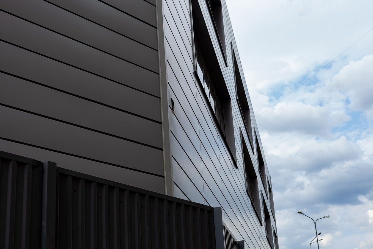 The facade of the building on the background of clouds
