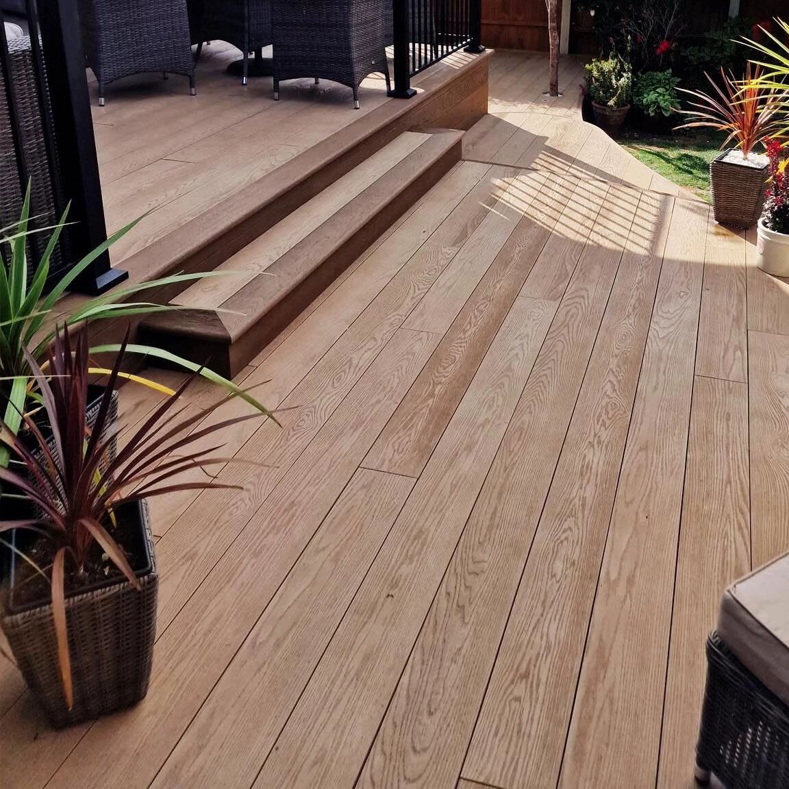 Flower pot on coppered oak floor board