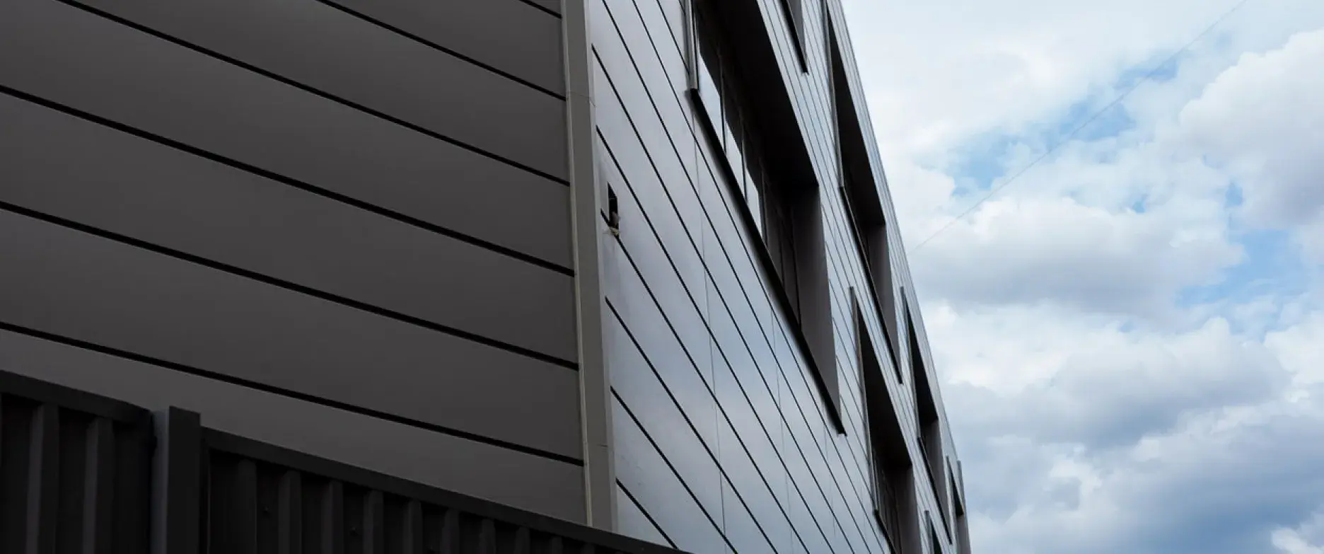 The facade of the building on the background of clouds