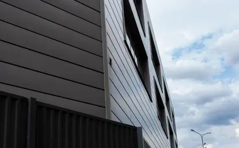 The facade of the building on the background of clouds
