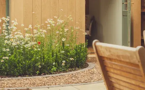 Light Wood cladding in a garden with golden oak chairs